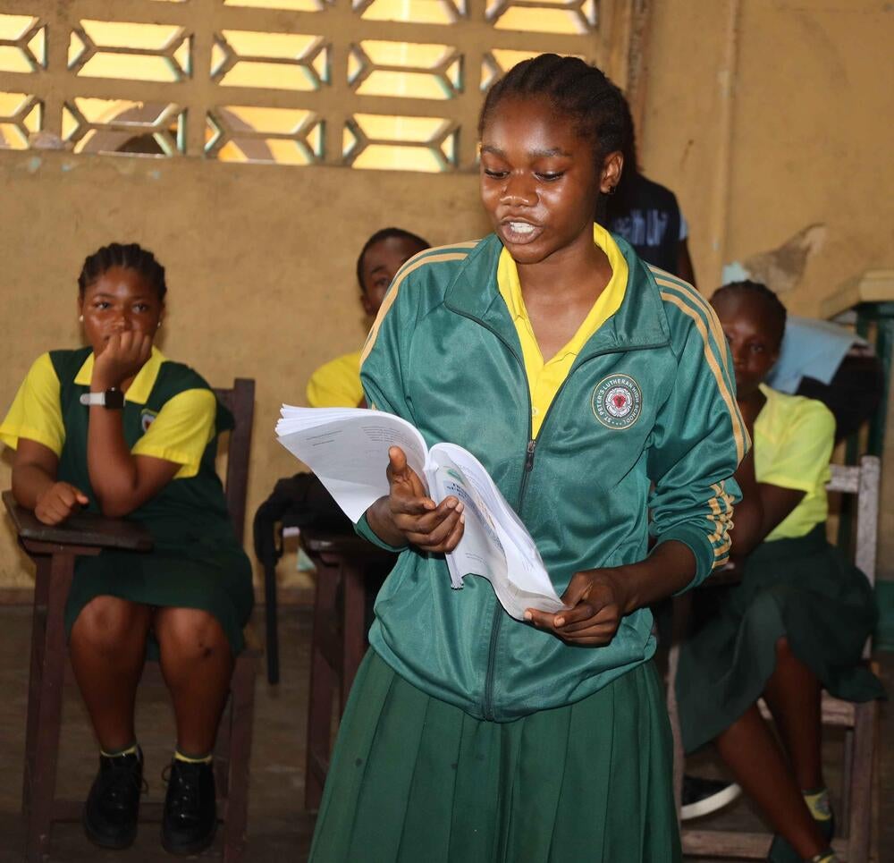 A Student at the St. Peter's Lutheran School reads the draft manual.