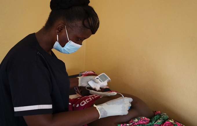 A midwife attends to a pregnant woman in Liberia