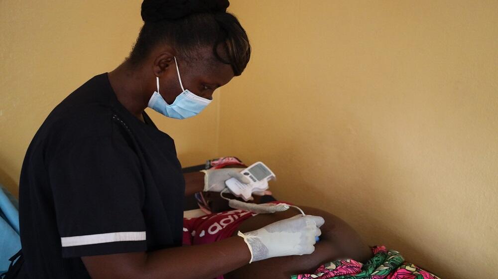 A midwife attends to a pregnant woman in Liberia